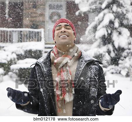 Man enjoying snow in front yard View Large Photo Image Stock Photo - Man enjoying snow in front yard. Fotosearch