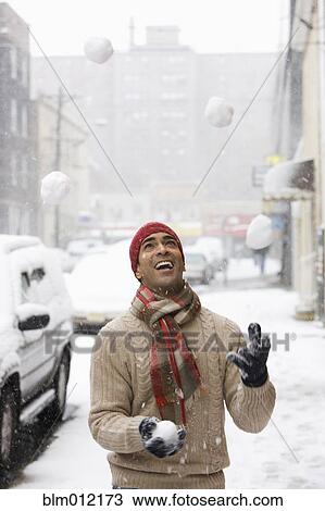 Man juggling snowballs in city View Large Photo Image Stock Image - Man juggling snowballs in city. Fotosearch