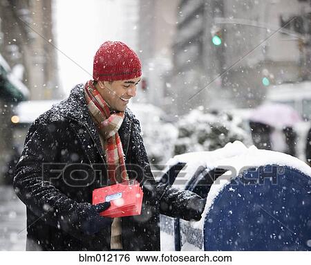 Man mailing Christmas cards in city View Large Photo Image Stock Photograph - Man mailing Christmas cards in city. Fotosearch