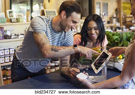 Man paying with credit card at store View Large Photo Image Stock Photo - Man paying with credit card at store. Fotosearch