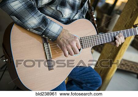 Stock Image - Man playing guitar. Fotosearch