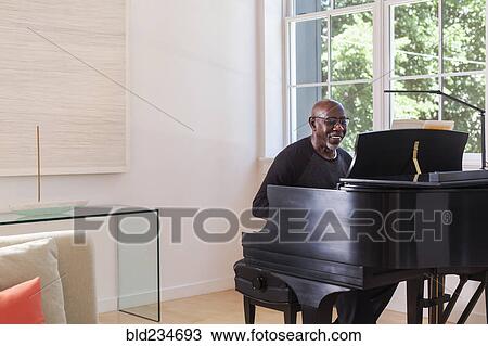 Man playing piano near window View Large Photo Image Stock Image - Man playing piano near window. Fotosearch
