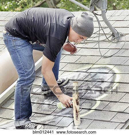 Man tagging roof with graffiti View Large Photo Image Stock Image - Man tagging roof with graffiti. Fotosearch