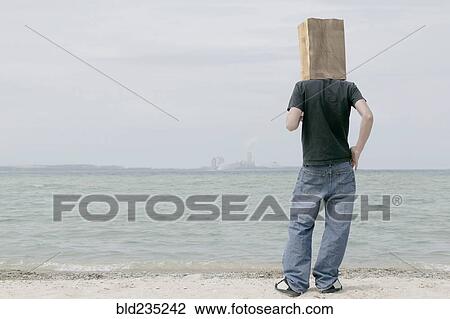 Man wearing paper bag on head watching distant skyline View Large Photo Image Stock Image - Man wearing paper bag on head watching distant skyline. Fotosearch