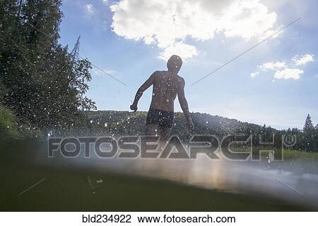 Mari man wading in lake View Large Photo Image Stock Image - Mari man wading in lake. Fotosearch