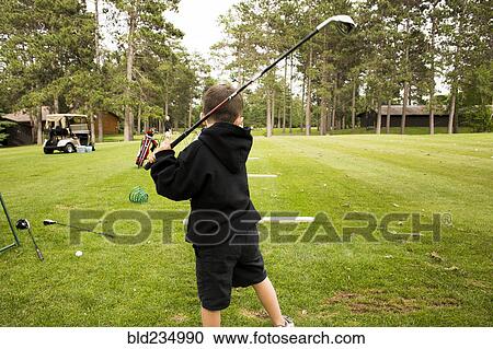 Mixed race boy swinging golf club View Large Photo Image Stock Image - Mixed race boy swinging golf club. Fotosearch