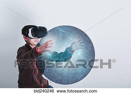 Mixed Race boy wearing VR goggles holding sphere View Large Photo Image Stock Photograph - Mixed Race boy wearing VR goggles holding sphere. Fotosearch