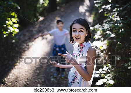 Mixed Race brother and sister on sunny path View Large Photo Image Stock Image - Mixed Race brother and sister on sunny path. Fotosearch