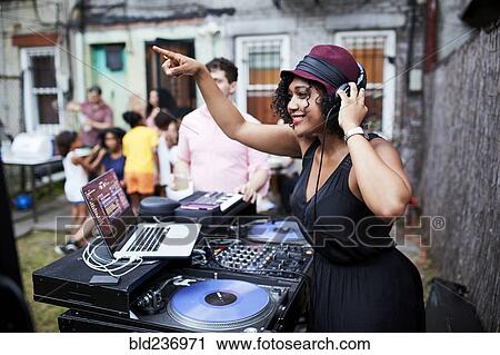 Mixed Race dj playing music at party in backyard View Large Photo Image Stock Image - Mixed Race dj playing music at party in backyard. Fotosearch