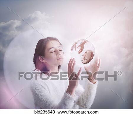 Mixed Race girl in clouds holding glass sphere View Large Photo Image Stock Image - Mixed Race girl in clouds holding glass sphere. Fotosearch