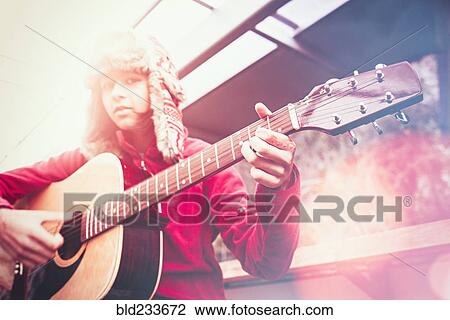 Mixed Race girl playing acoustic guitar View Large Photo Image Stock Image - Mixed Race girl playing acoustic guitar. Fotosearch
