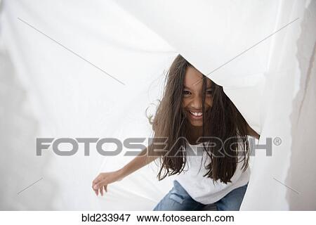 Mixed Race girl playing with curtain View Large Photo Image Stock Photo - Mixed Race girl playing with curtain. Fotosearch