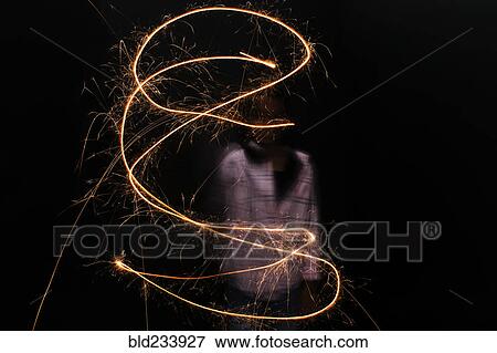Mixed Race girl twirling sparkler View Large Photo Image Stock Photo - Mixed Race girl twirling sparkler. Fotosearch