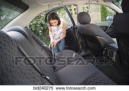 Mixed Race girl vacuuming car interior View Large Photo Image Stock Photography - Mixed Race girl vacuuming car interior. Fotosearch