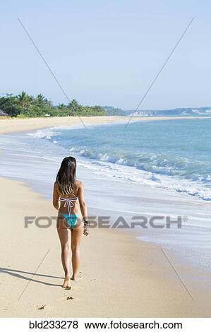 Mixed Race girl walking on beach View Large Photo Image Stock Photo - Mixed Race girl walking on beach. Fotosearch