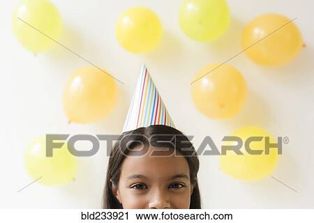 Mixed Race girl wearing party hat View Large Photo Image Stock Image - Mixed Race girl wearing party hat. Fotosearch