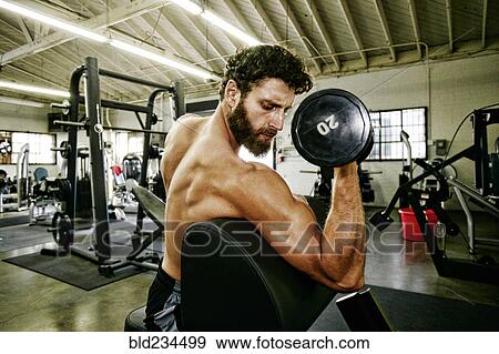 Mixed Race man lifting dumbbell in gymnasium View Large Photo Image Stock Photo - Mixed Race man lifting dumbbell in gymnasium. Fotosearch