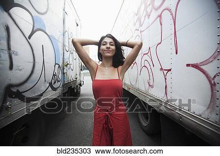 Mixed Race woman between semi-trucks with graffiti View Large Photo Image Stock Image - Mixed Race woman between semi-trucks with graffiti. Fotosearch