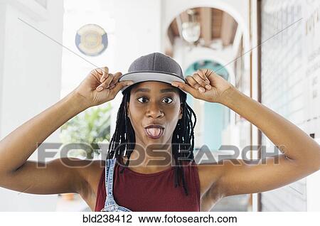 Stock Image - Mixed Race woman making a face. Fotosearch