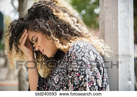 Mixed Race woman rubbing forehead View Large Photo Image Stock Image - Mixed Race woman rubbing forehead. Fotosearch