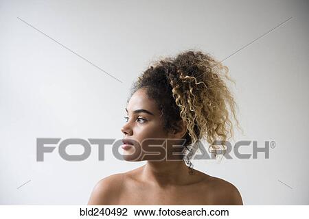 Mixed Race woman with bare shoulders looking away View Large Photo Image Stock Image - Mixed Race woman with bare shoulders looking away. Fotosearch