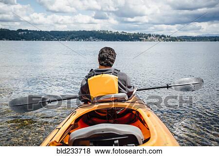 Mixed Rave man sitting in kayak holding paddle View Large Photo Image Stock Photo - Mixed Rave man sitting in kayak holding paddle. Fotosearch