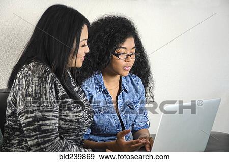 Stock Photo - Mother and daughter using laptop. Fotosearch