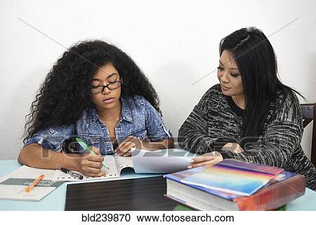 Mother helping daughter with homework View Large Photo Image Stock Image - Mother helping daughter with homework. Fotosearch