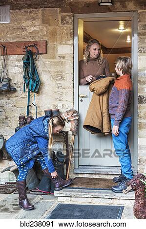 Mother standing in french-door doorway with son and daughter View Large Photo Image Stock Image - Mother standing in french-door doorway with son and daughter. Fotosearch