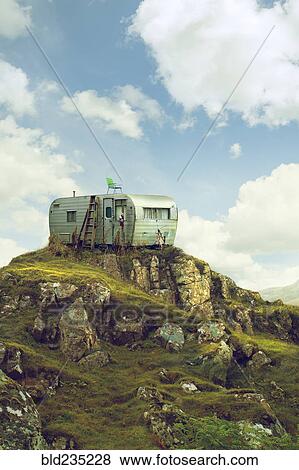 Motor home on hill in green landscape View Large Photo Image Stock Photo - Motor home on hill in green landscape. Fotosearch
