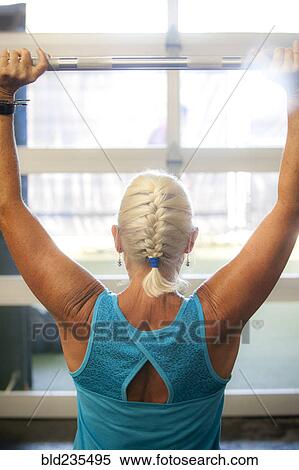 Older woman lifting barbell in gymnasium View Large Photo Image Stock Photography - Older woman lifting barbell in gymnasium. Fotosearch
