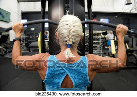 Older woman working out in gymnasium View Large Photo Image Stock Image - Older woman working out in gymnasium. Fotosearch
