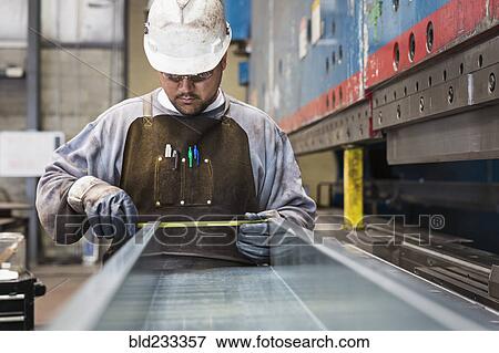Pacific Islander worker measuring metal in factory View Large Photo Image Stock Photo - Pacific Islander worker measuring metal in factory. Fotosearch