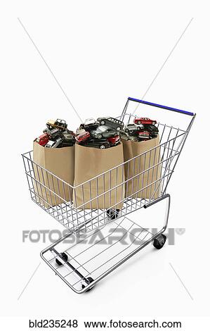 Paper bags in shopping cart filled with cars View Large Photo Image Stock Photo - Paper bags in shopping cart filled with cars. Fotosearch