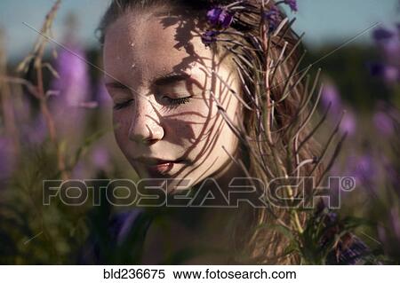 Pensive Caucasian girl sweating near wildflowers View Large Photo Image Stock Photography - Pensive Caucasian girl sweating near wildflowers. Fotosearch