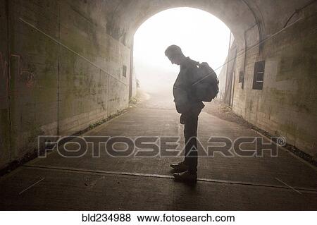 Pensive Caucasian man standing in tunnel View Large Photo Image Stock Photo - Pensive Caucasian man standing in tunnel. Fotosearch