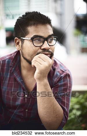 Pensive Hispanic man with hand on chin View Large Photo Image Stock Image - Pensive Hispanic man with hand on chin. Fotosearch