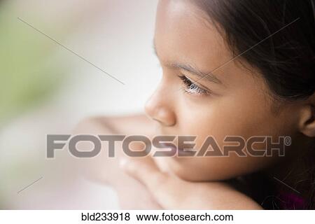 Pensive Mixed Race girl resting chin on hand View Large Photo Image Stock Photo - Pensive Mixed Race girl resting chin on hand. Fotosearch