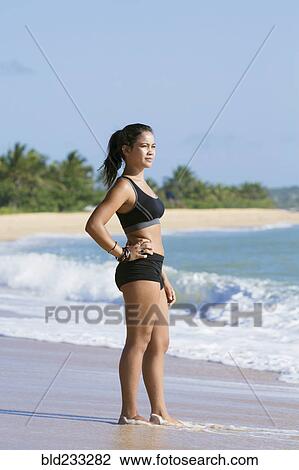Pensive Mixed Race girl standing on beach View Large Photo Image Stock Image - Pensive Mixed Race girl standing on beach. Fotosearch