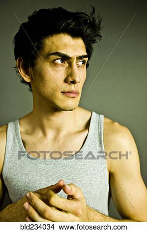 Picture - Pensive Mixed Race man wearing tank-top. Fotosearch