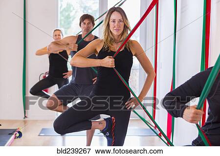 People pulling on resistance bands in gymnasium View Large Photo Image Stock Photo - People pulling on resistance bands in gymnasium. Fotosearch