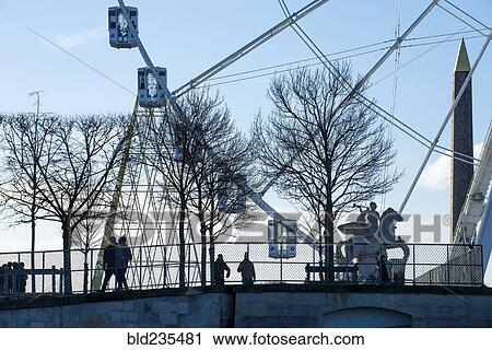 "People walking near ferris wheel in Paris, France" View Large Photo Image Stock Image - "People walking near ferris wheel in Paris, France". Fotosearch