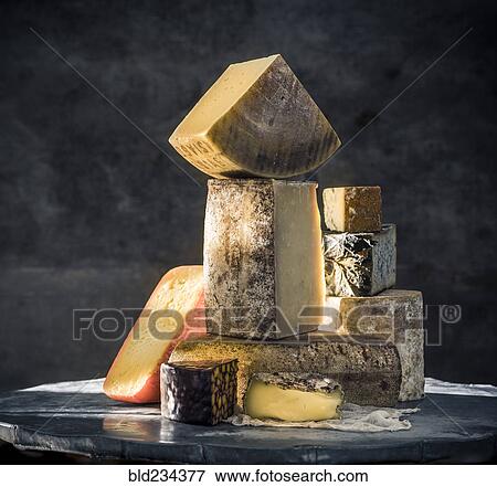 Stock Photo - Pile of variety of cheeses. Fotosearch