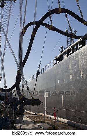 Pipes connecting hoses to freighter at port View Large Photo Image Stock Photography - Pipes connecting hoses to freighter at port. Fotosearch