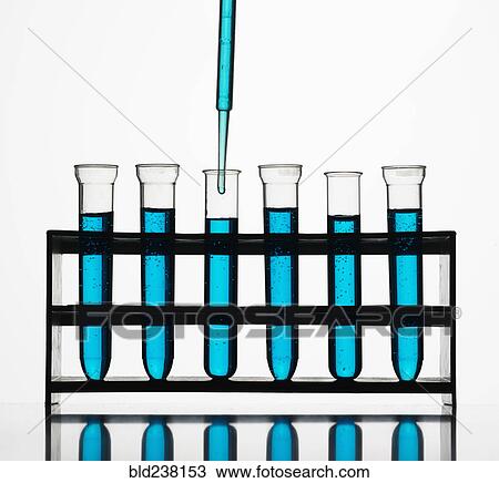 Pipette dripping blue liquid into test tubes View Large Photo Image Stock Image - Pipette dripping blue liquid into test tubes. Fotosearch