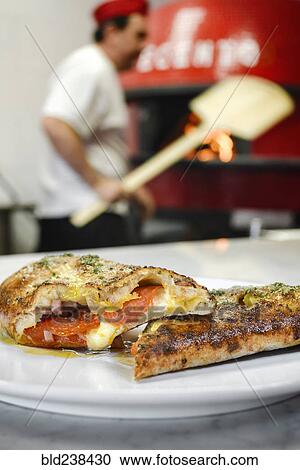 Pizza slices on plate in pizzeria View Large Photo Image Stock Image - Pizza slices on plate in pizzeria. Fotosearch