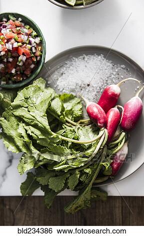 Stock Photograph - Plate of radishes with sea salt and pico de gallo. Fotosearch