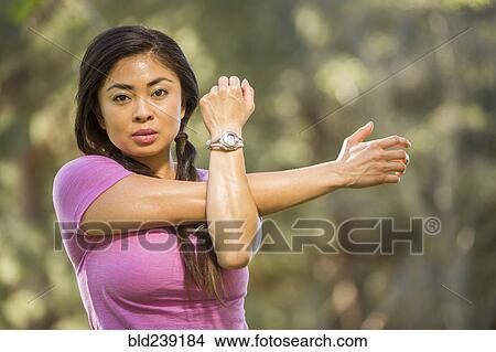 Portrait of Asian woman stretching arms View Large Photo Image Picture - Portrait of Asian woman stretching arms. Fotosearch