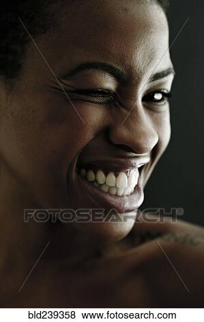 Stock Photo - Portrait of Black woman winking. Fotosearch