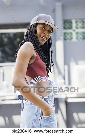 Stock Photograph - Portrait of casual smiling Mixed Race woman. Fotosearch